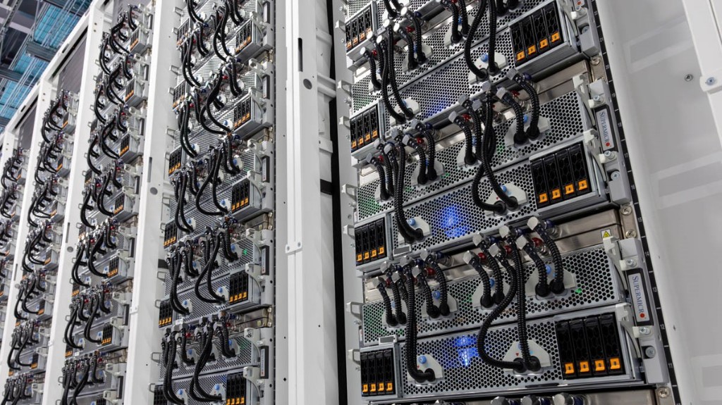 White server racks with dense compute hardware and organised cabling